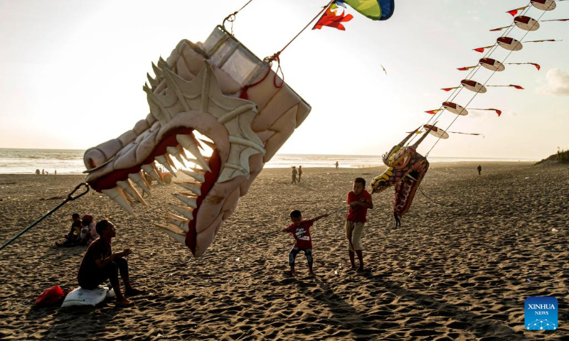 People fly dragon kites at Parangkusumo beach in Bantul district, Yogyakarta, Indonesia, on Dec. 17, 2023. (Photo by Agung Supriyanto/Xinhua)