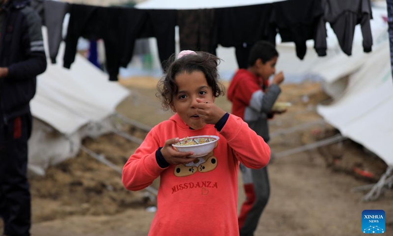 Palestinian children are seen at a temporary shelter in the southern Gaza Strip city of Rafah, on Dec. 13, 2023. Hamas leader Ismail Haniyeh said on Wednesday that the Gaza-ruling Palestinian faction is ready to discuss with Israel any arrangement or initiative that could lead to a ceasefire in Gaza.(Photo: Xinhua)