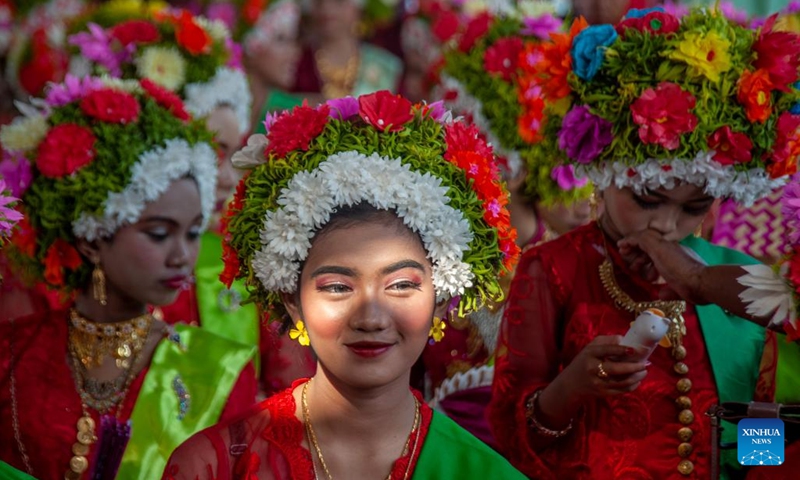 Girls decorated with flowers on their heads interact with each other before participating in a celebration for the traditional Ngarot festival at Lelea village in Indramayu district, West Java, Indonesia, on Dec. 13, 2023. Ngarot is a traditional ceremony in Indramayu of West Java Province held to welcome the rice planting season.(Photo: Xinhua)