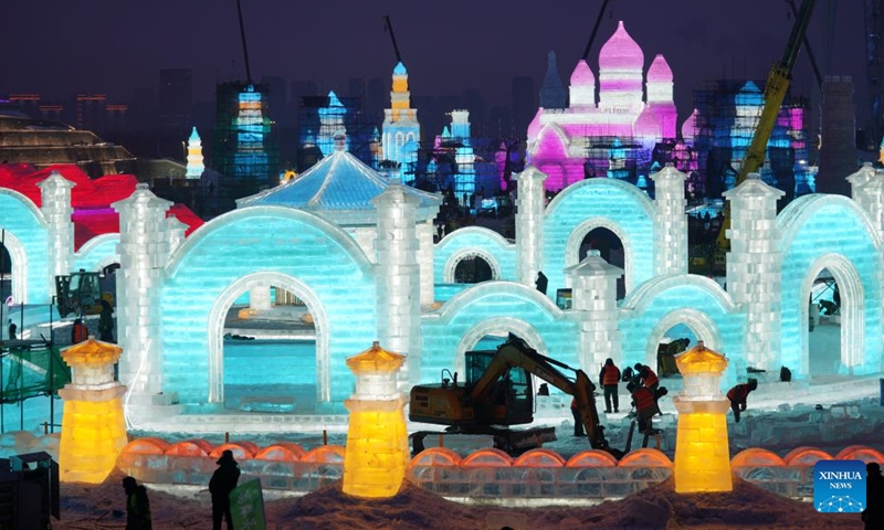 Workers are seen at the construction site of the Harbin Ice and Snow World, a renowned seasonal theme park opening every winter, in Harbin, northeast China's Heilongjiang Province, Dec. 12, 2023. Harbin Ice and snow World will open for its 25th winter season on Dec. 18. It is estimated that 250,000 cubic meters of ice and snow will be used in its construction.(Photo: Xinhua)