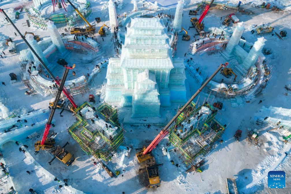 This aerial photo taken on Dec. 12, 2023 shows the construction site of the Harbin Ice and Snow World, a renowned seasonal theme park opening every winter, in Harbin, northeast China's Heilongjiang Province. Harbin Ice and snow World will open for its 25th winter season on Dec. 18. It is estimated that 250,000 cubic meters of ice and snow will be used in its construction.(Photo: Xinhua)