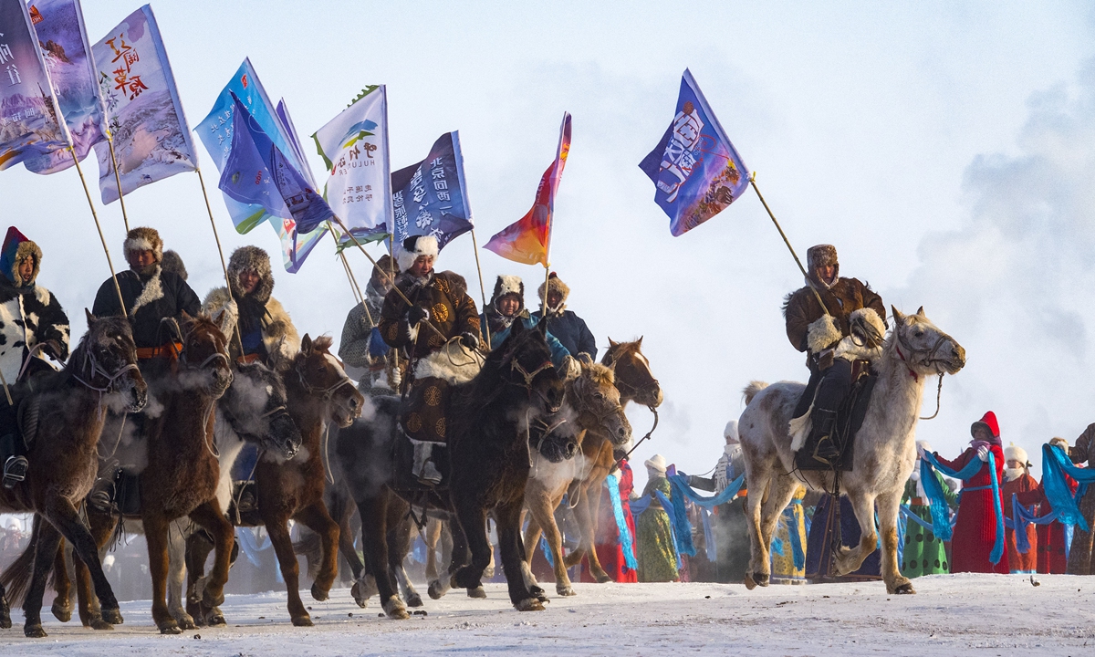 Horsemen hold banners at the opening ceremony of the 20th Ice and Snow Nadam of North China's Inner Mongolia Autonomous Region in Old Barag Banner in Hulun Buir on December 17, 2023. More than 10,000 tourists from Russia, Mongolia, Malaysia, and various parts of China came to experience the charm of the Hulun Buir. The event will continue until March 2024.Photo: VCG