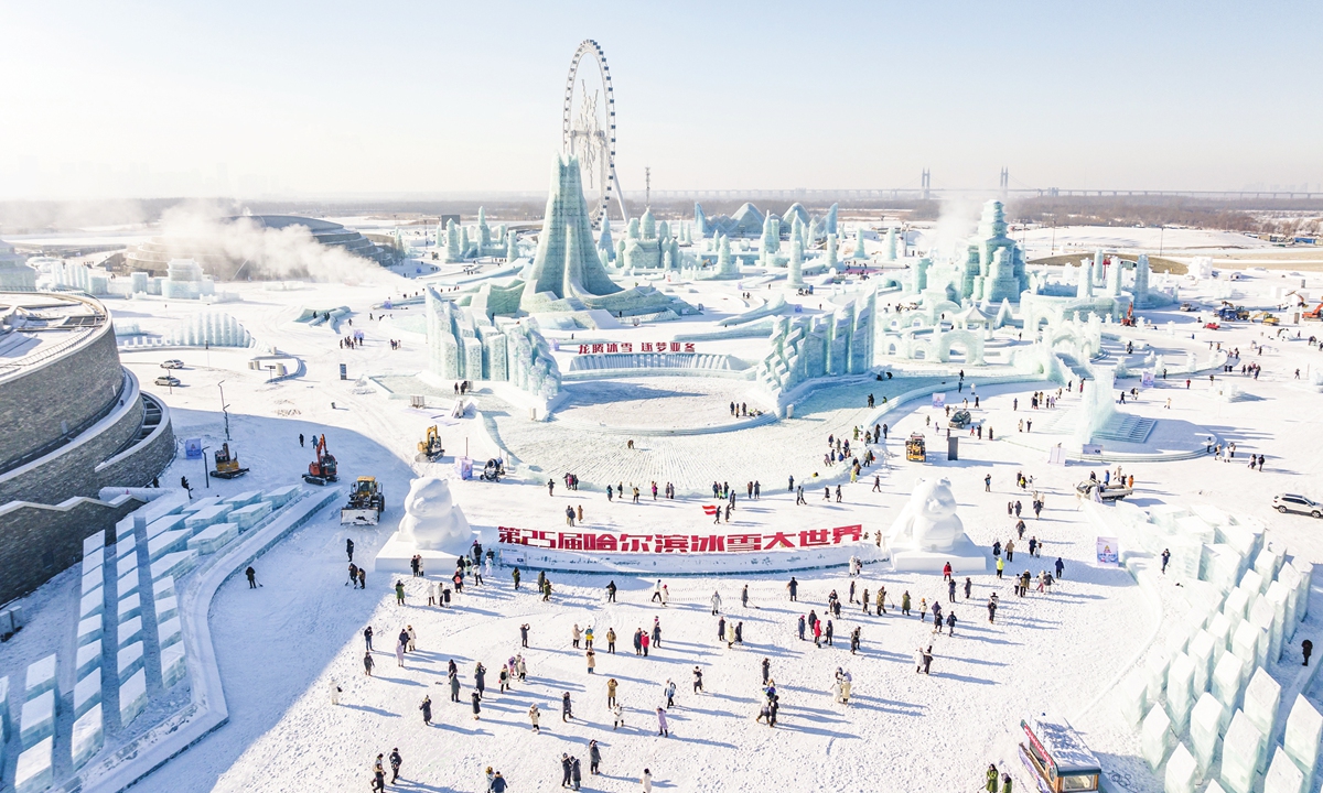 People explore the 25th Harbin Ice and Snow World in Northeast China's Heilongjiang Province on its opening day, December 18, 2023. The park covers an area of 810,000 square meters, while a total of 250,000 cubic meters of snow and ice has been used. Photo: VCG