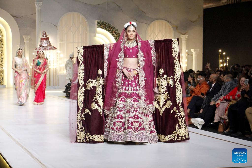 Models present creations on the last day of the Bridal Couture Week in Lahore, Pakistan, Dec. 17, 2023.(Photo: Xinhua)