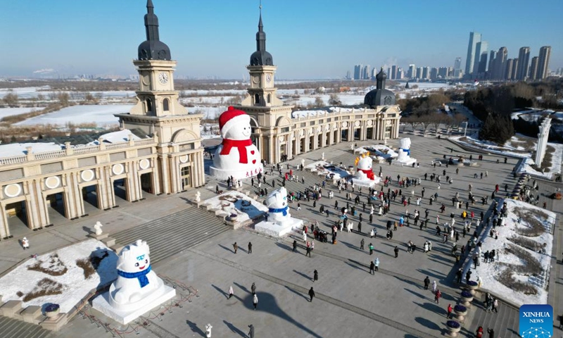 This aerial photo taken on Dec. 17, 2023 shows a giant snowman in Harbin, northeast China's Heilongjiang Province. The giant snowman, about 18 meters in height and made with some 2,000 cubic meters of snow, becomes a yearly landmark of Harbin.(Photo: Xinhua)