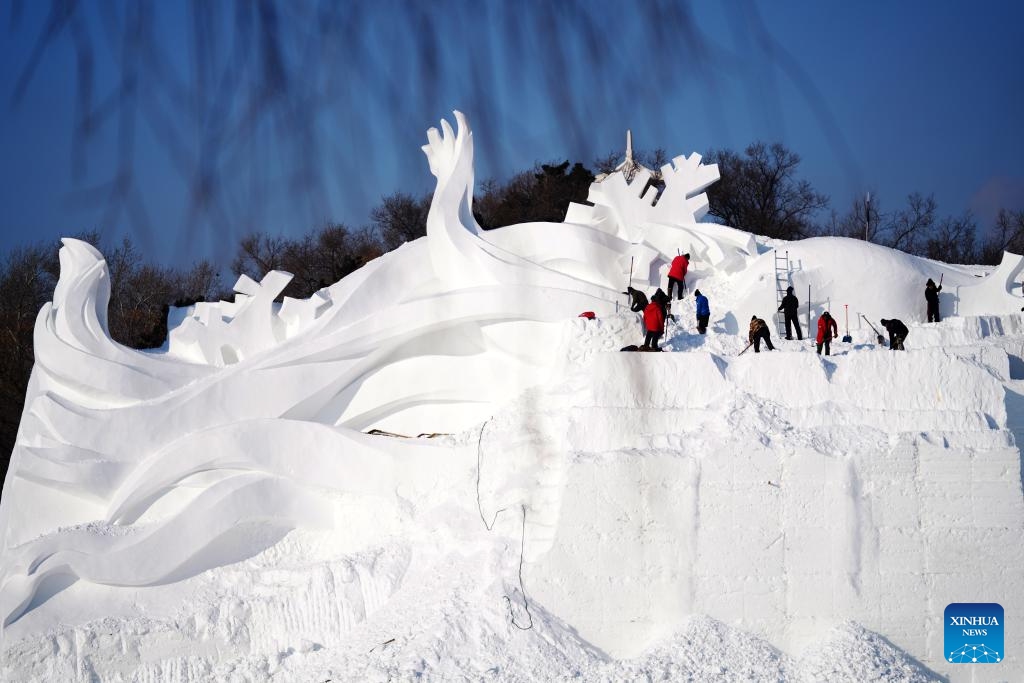 Sculptors work on a giant snow sculpture at the Sun Island scenic area in Harbin, northeast China's Heilongjiang Province, Dec. 19, 2023. Sculptors have been busy with snow sculpture works for the upcoming 36th Sun Island International Snow Sculpture Expo in Harbin.（Photo: Xinhua)