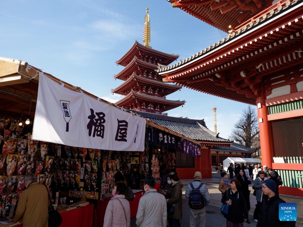 People visit a yearend fair in Asakusa, Tokyo, Japan, Dec. 19, 2023. The yearend event, also named Hagoita Fair, is held at Asakusa, Tokyo from Dec. 17 to 19. The fair has a history of more than 100 years.（Photo: Xinhua)