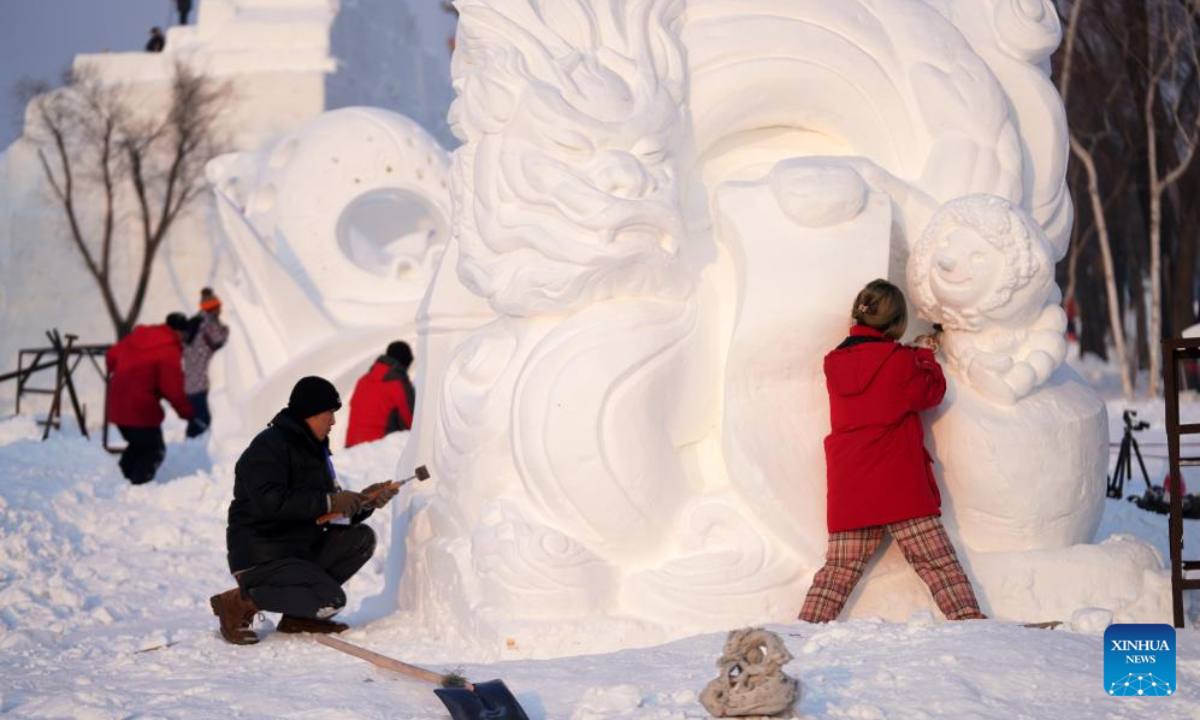 Contestants work on snow sculptures at the 30th National Snow Sculpture Contest in Harbin, northeast China's Heilongjiang Province, Dec 28, 2023. Photo:Xinhua