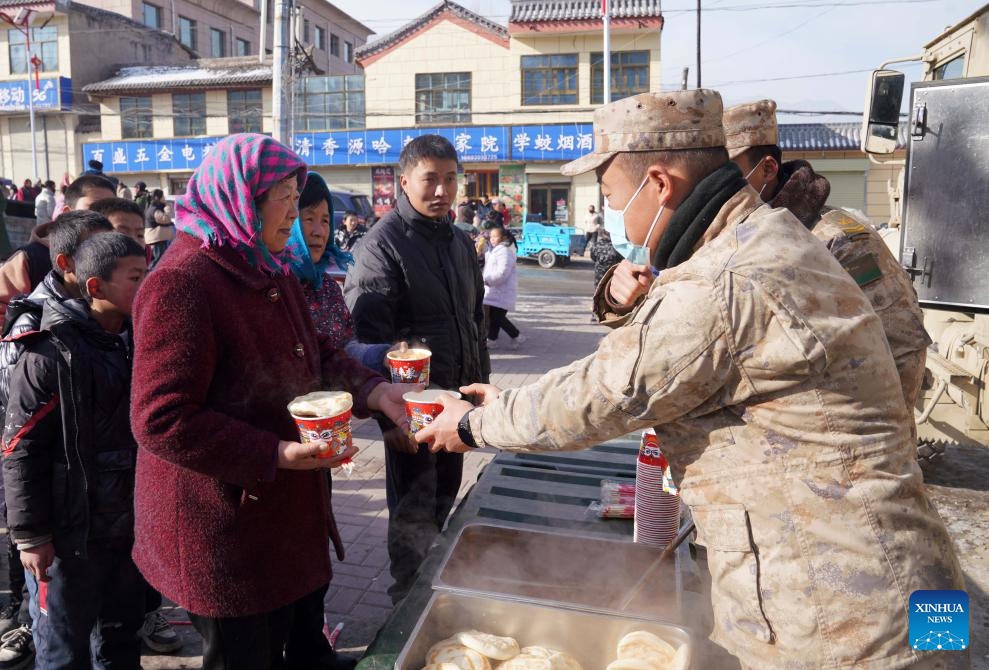 Soldiers provide hot food for quake-affected people in Liuji Township, Jishishan County, northwest China's Gansu Province, Dec. 21, 2023. The Chinese People's Liberation Army (PLA) and the People's Armed Police Force (PAPF) have deployed multiple rescue forces to quake-hit areas in response to a 6.2-magnitude earthquake that jolted northwest China's Gansu Province late Monday.(Photo: Xinhua)