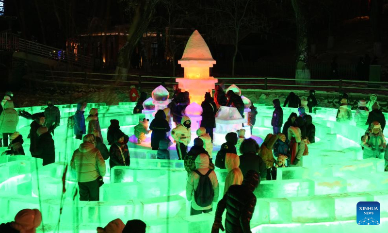 People visit the 50th Harbin ice lantern fair in Harbin, northeast China's Heilongjiang Province, Dec. 31, 2023. The ice lantern fair kicked off here on Sunday. (Xinhua/Wang Jianwei)