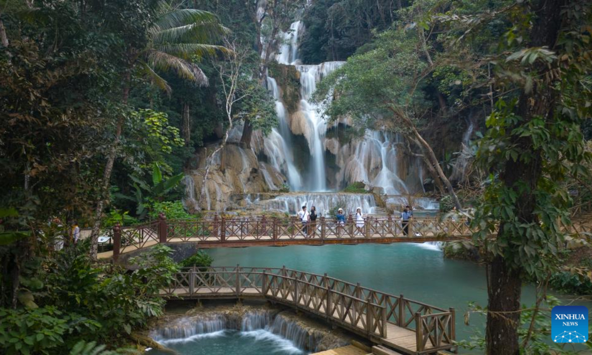 This aerial photo taken on Dec 30, 2023 shows people visiting the Kuang Si waterfall in Luang Prabang, Laos. Photo:Xinhua