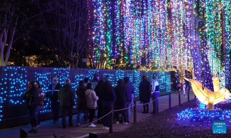 People visit the Houston Zoo Lights held in Houston, Texas, the United States, Dec. 30, 2023. The Houston Zoo Lights runs from Nov. 17, 2023 through Jan. 7, 2024. (Xinhua/Xu Jianmei)