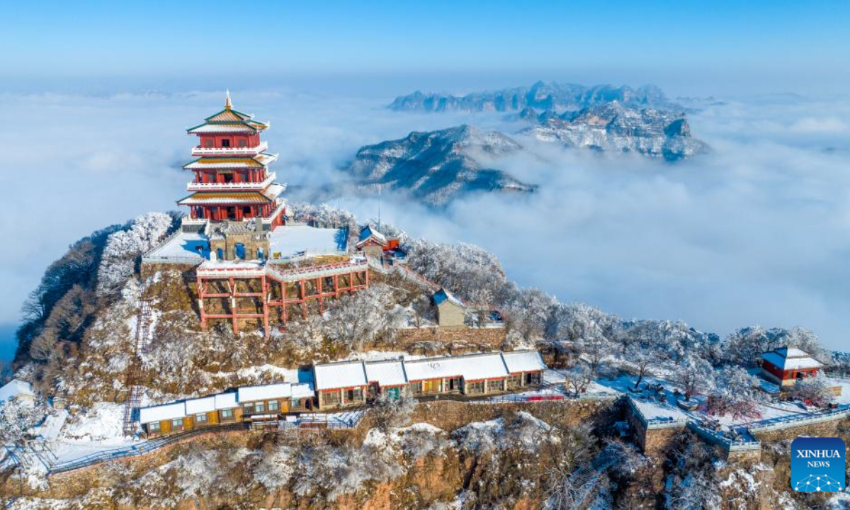 This aerial photo taken on Dec 12, 2023 shows scenery of the Wangwu Mountain scenic spot in Jiyuan City, central China's Henan Province. A rendezvous with snow refreshes the landscapes as winter leaves its steps in most parts of China.Photo:Xinhua