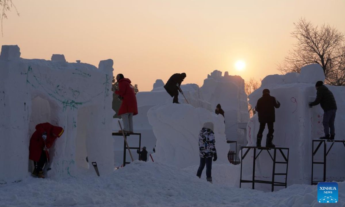 Contestants work on snow sculptures at the 30th National Snow Sculpture Contest in Harbin, northeast China's Heilongjiang Province, Dec 28, 2023. Photo:Xinhua