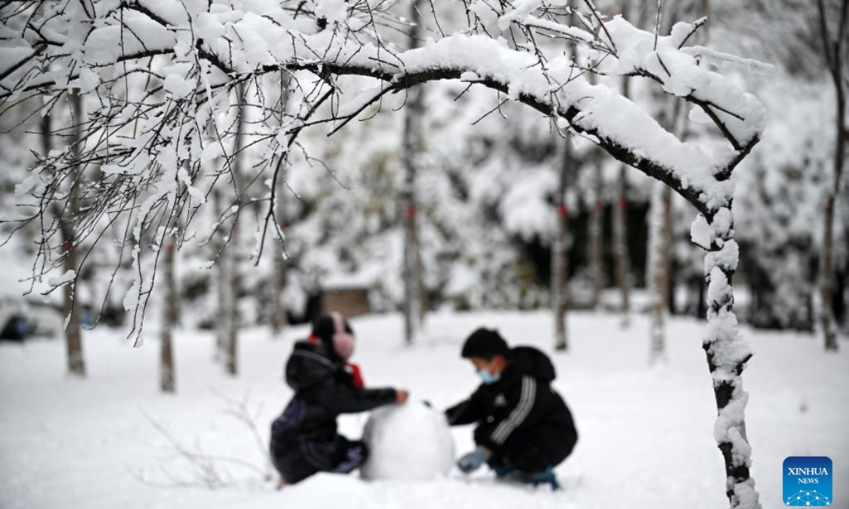 Children build a snowman in Qinyang City, central China's Henan Province, Dec 11, 2023. A rendezvous with snow refreshes the landscapes as winter leaves its steps in most parts of China. Photo:Xinhua