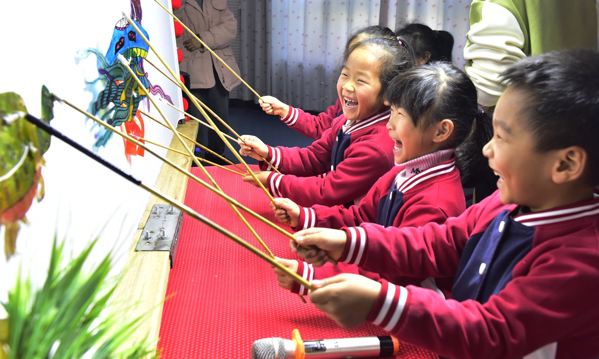 Children have fun playing with shadow play puppets at a kindergarten in Hefei, East China's Anhui Province, on December 21, 2023. Shadow play, also known as shadow puppetry, is a folk performance art that originated in China. Photo: VCG