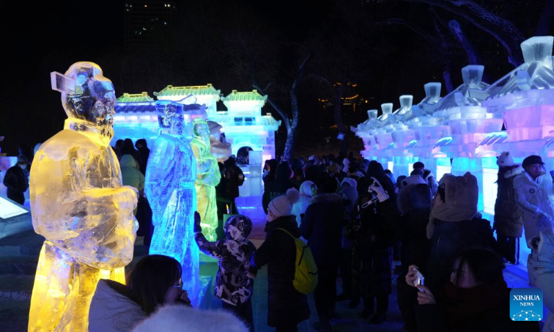 People visit the 50th Harbin ice lantern fair in Harbin, northeast China's Heilongjiang Province, Dec. 31, 2023. The ice lantern fair kicked off here on Sunday. (Xinhua/Wang Jianwei)