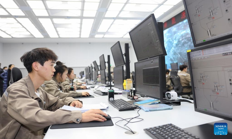 People work at the control center of a new energy company of the Xinjiang Production and Construction Corps in northwest China's Xinjiang Uygur Autonomous Region, Dec. 23, 2023. (Xinhua/Hu Huhu)