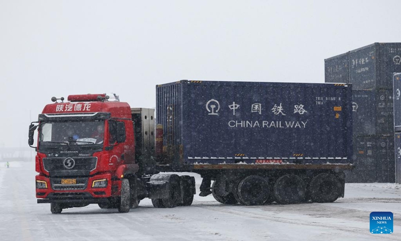 A truck transports cargoes at a multimodal international logistics port of the Xinjiang Production and Construction Corps in northwest China's Xinjiang Uygur Autonomous Region, Dec. 22, 2023. (Xinhua/Hu Huhu)