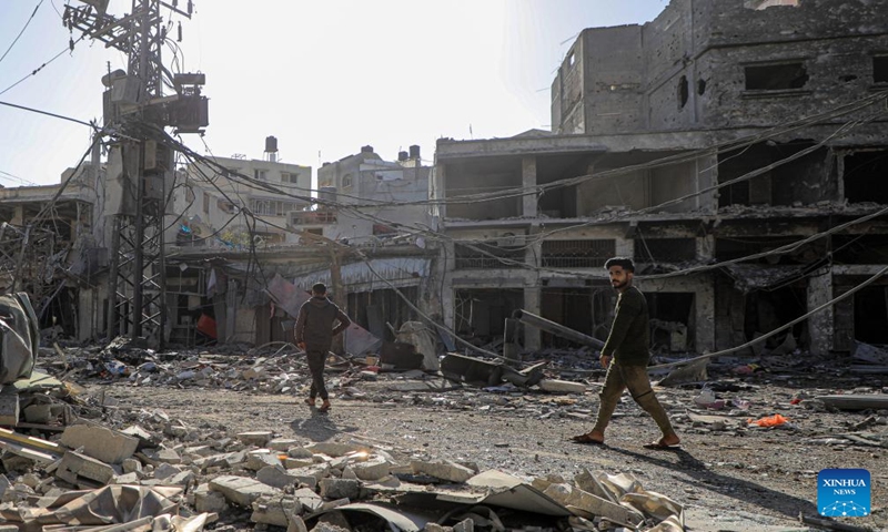 People inspect the damage after an Israeli strike in the southern Gaza Strip city of Khan Younis, on Dec. 24, 2023. At least 166 Palestinians were killed and 384 others were wounded during the past 24 hours by the ongoing Israeli attacks on the Gaza Strip, said the Gaza-based Health Ministry on Sunday. (Photo by Rizek Abdeljawad/Xinhua)