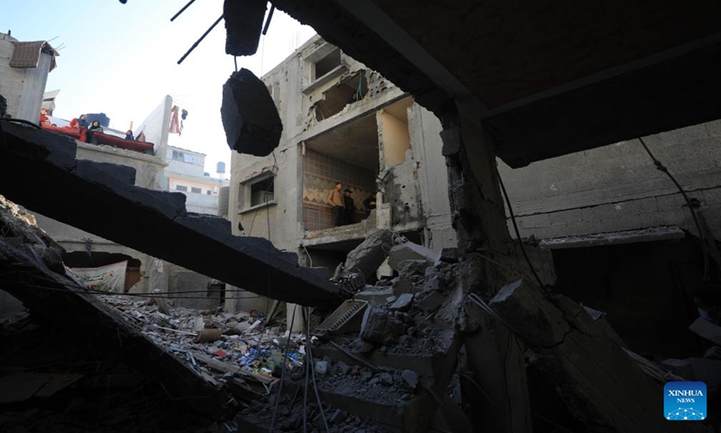 People inspect the rubble after an Israeli airstrike in the southern Gaza Strip city of Rafah, Dec. 24, 2023. At least 166 Palestinians were killed and 384 others were wounded during the past 24 hours by the ongoing Israeli attacks on the Gaza Strip, said the Gaza-based Health Ministry on Sunday. (Photo by Yasser Qudih/Xinhua)