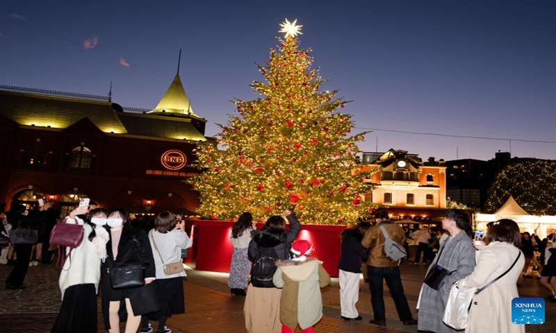 People take photos of a Christmas tree at a square in Ebisu, Tokyo, Japan, Dec. 21, 2023. (Xinhua/Zhang Xiaoyu)