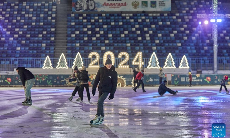 People skate at the Pioneer ice rink in Vladivostok, Russia, Dec. 25, 2023. Pioneer, the largest ice rink in Russia's Far East city of Vladivostok, opened to the public on Monday.(Photo: Xinhua)