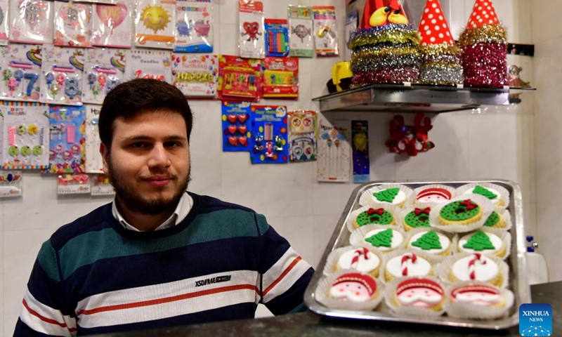 A seller showcases festive handcrafted sweets for Christmas celebrations in Damascus, Syria, Dec. 24, 2023.(Photo: Xinhua)