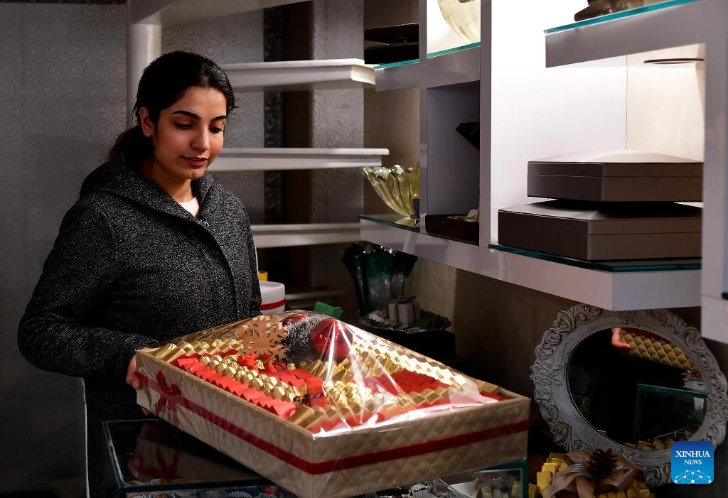 A seller showcases festive handcrafted sweets for Christmas celebrations in Damascus, Syria, Dec. 24, 2023.(Photo: Xinhua)