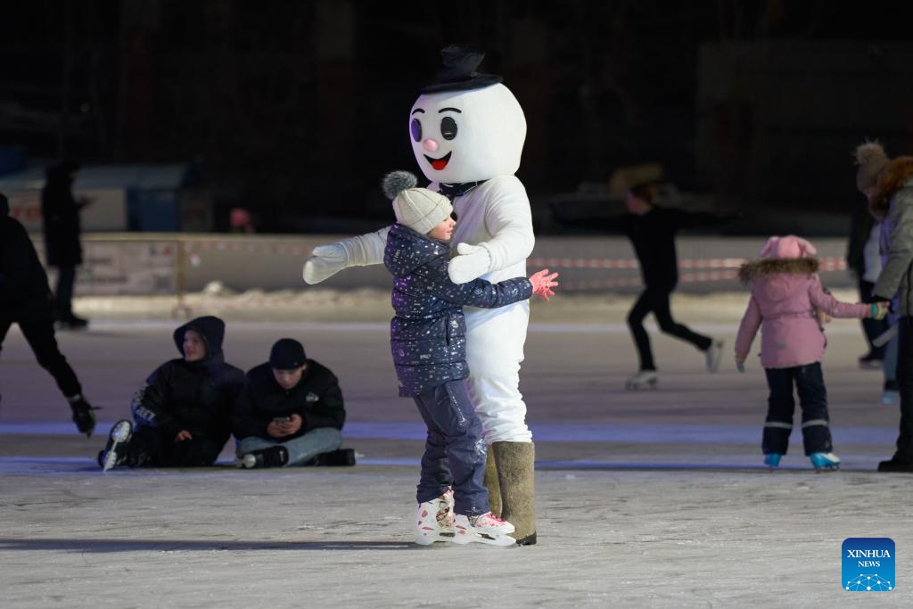 People skate at the Pioneer ice rink in Vladivostok, Russia, Dec. 25, 2023. Pioneer, the largest ice rink in Russia's Far East city of Vladivostok, opened to the public on Monday.(Photo: Xinhua)