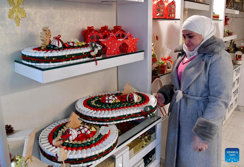 A seller showcases festive handcrafted sweets for Christmas celebrations in Damascus, Syria, Dec. 24, 2023.(Photo: Xinhua)