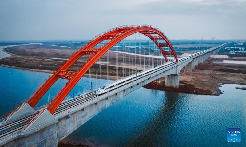 This aerial photo taken on Dec. 12, 2023 shows a high-speed train passing a grand bridge at Poyang Lake during a test run on Hangzhou-Nanchang high-speed railway in east China's Anhui Province. Huangshan to Nanchang section of Hangzhou-Nanchang high-speed railway will start operation on Dec. 27, marking the full operation of the Hangzhou-Nanchang high-speed railway.(Photo: Xinhua)