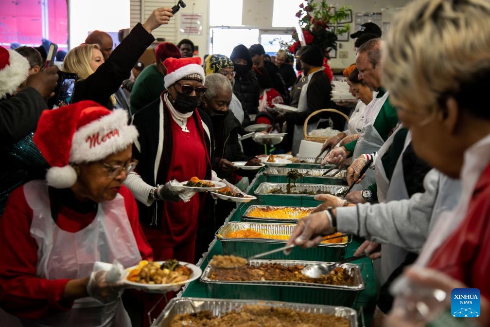 People are served food during the National Action Network (NAN) Christmas Dinner and Toy Distribution at the House of Justice in Harlem, New York, the United States, Dec. 25, 2023. NAN offered free meals and toys to local residents at the House of Justice in Harlem on Monday. (Photo: Xinhua)