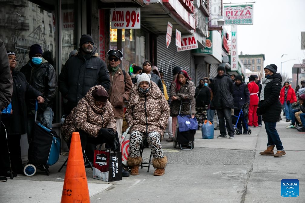 People wait in line during the National Action Network (NAN) Christmas Dinner and Toy Distribution at the House of Justice in Harlem, New York, the United States, Dec. 25, 2023. NAN offered free meals and toys to local residents at the House of Justice in Harlem on Monday.(Photo: Xinhua)