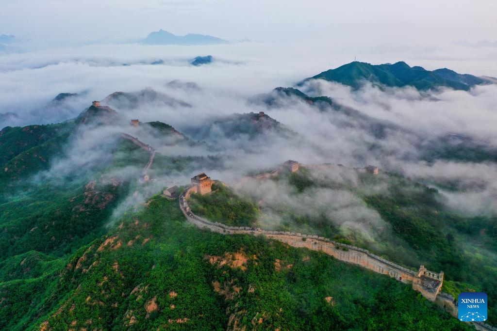 This aerial photo taken on July 23, 2023 shows the summer scenery at the Jinshanling section of the Great Wall in Luanping County, north China's Hebei Province. With the change of the four seasons, the Jinshanling section of the Great Wall puts on different layers of colors and shows magnificent beauty.(Photo: Xinhua)