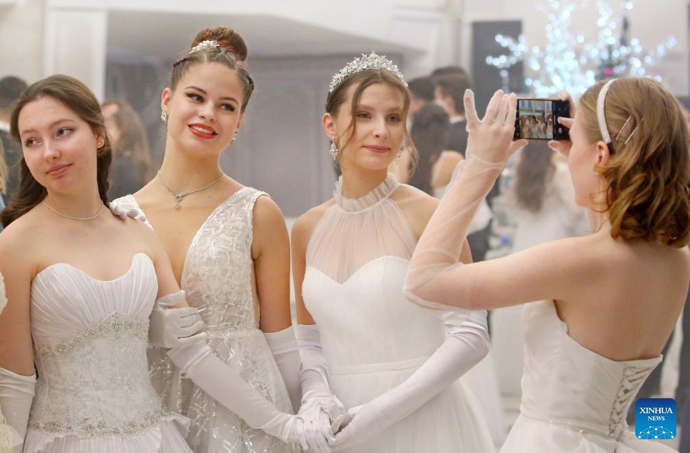 People pose for photos at a ball to welcome the upcoming New Year in Minsk, capital of Belarus, on Dec. 26, 2023.(Photo: Xinhua)