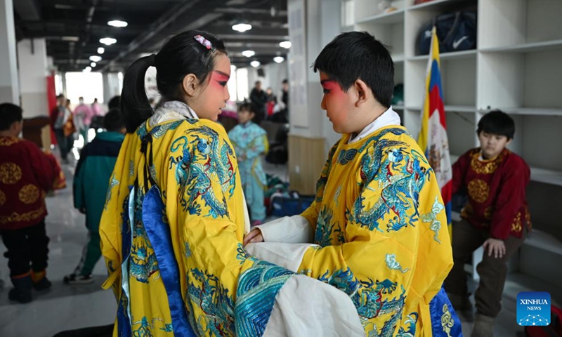 Students prepare for an opera performance at a school in Baoding, north China's Hebei Province, Dec. 27, 2023. In recent years, activities related to operas were introduced to the campus life in Lianchi district of Baoding City, offering local students opportunities to feel and inherit the traditional culture.(Photo: Xinhua)