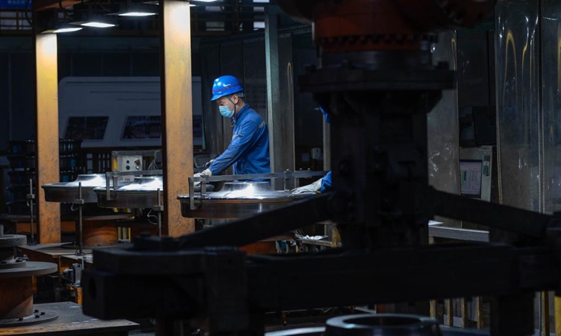 An employee measures the external diameter of a wheel at a workshop in China Baowu Group Masteel Rail Transit Materials Technology Co., Ltd. (MRT) in Ma'anshan, east China's Anhui Province, Dec. 15, 2023. (Photo: Xinhua)