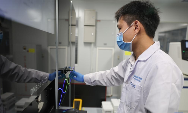 A researcher conducts experiments at a seed laboratory in Sanya, south China's Hainan Province, Dec. 29, 2023. Sanya's abundance of sunlight expedites the breeding cycle, drawing numerous researchers from across the country to breed new species of crops every October till the next April. (Photo: Xinhua)