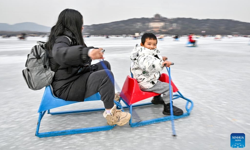 Tourists have fun on a frozen lake at the Summer Palace in Beijing, capital of China, Jan. 1, 2024. (Photo:Xinhua)