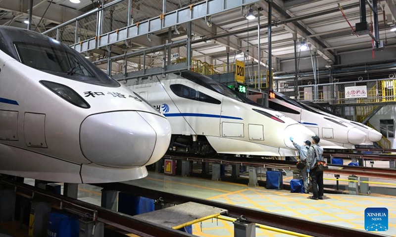 Staff members check the nose part of a high-speed electrical multiple unit (EMU) train at a maintenance station in Hohhot, north China's Inner Mongolia Autonomous Region, Jan. 2, 2024. Staff members at the maintenance station were busy servicing the EMU trains on Tuesday so as to guarantee their normal operations after the New Year holiday travel rush. (Photo: Xinhua)