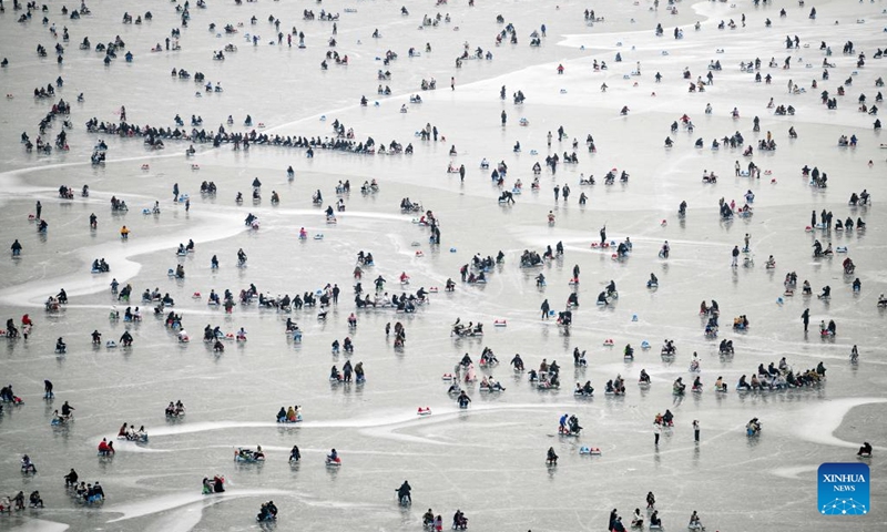 Tourists have fun on a frozen lake at the Summer Palace in Beijing, capital of China, Jan. 1, 2024. (Photo:Xinhua)