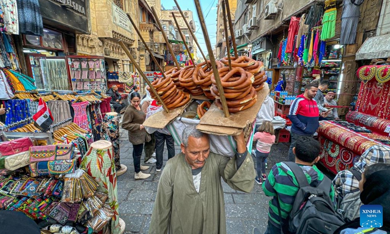 A vendor sells bread at an old market in Cairo, Egypt, Dec. 31, 2023. (Photo: Xinhua)