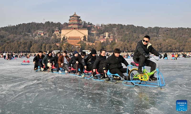 Tourists have fun on a frozen lake at the Summer Palace in Beijing, capital of China, Jan. 1, 2024. (Photo:Xinhua)