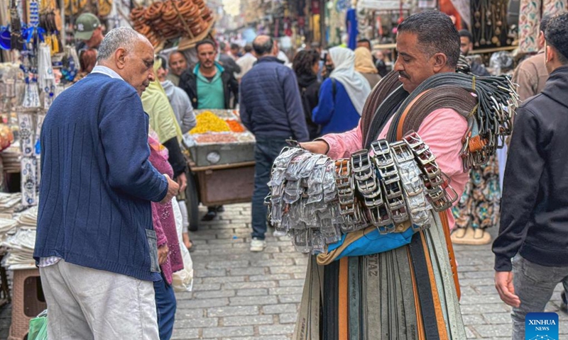 A vendor sells belts at an old market in Cairo, Egypt, Dec. 31, 2023.(Photo: Xinhua)