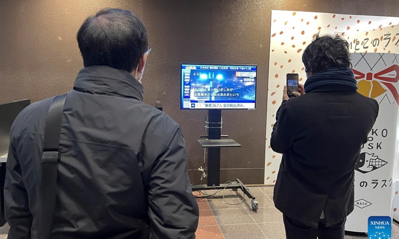 People watch a television screen showing a news broadcast of an aircraft collision at Haneda Airport in Tokyo, Japan, Jan. 2, 2024. (Photo: Xinhua)