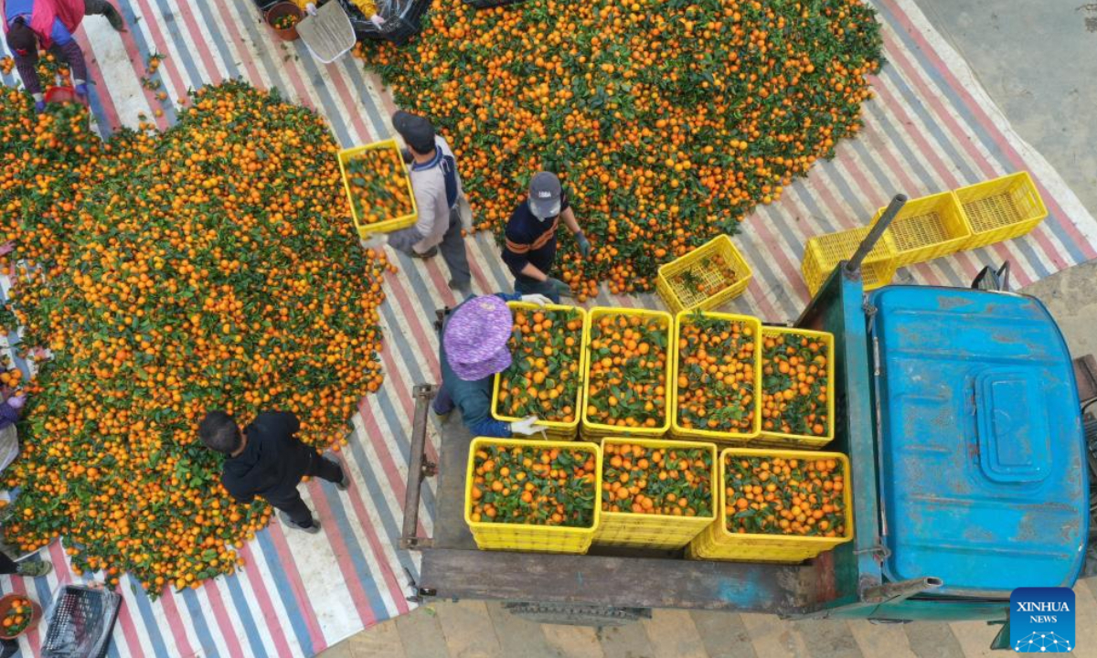 This aerial photo taken on Jan 5, 2024 shows villagers unloading 