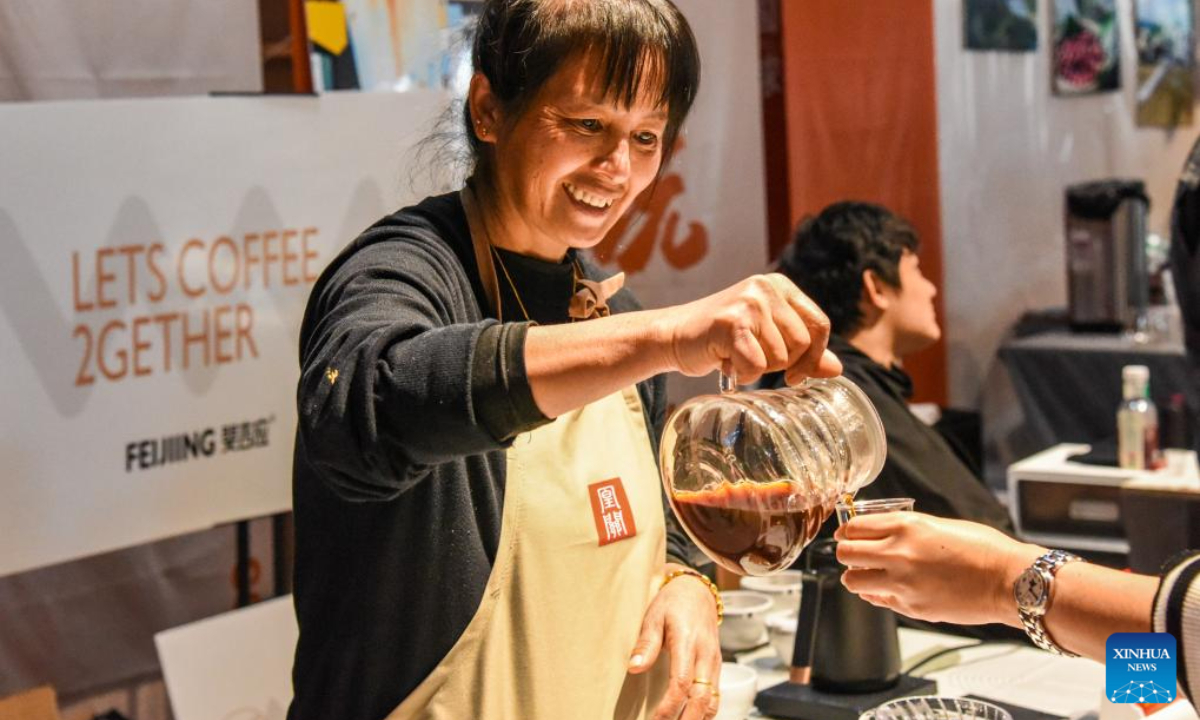 An exhibitor serves coffee during China (Pu'er) International Coffee Expo in Pu'er, southwest China's Yunnan Province, Jan 5, 2024. Photo:Xinhua