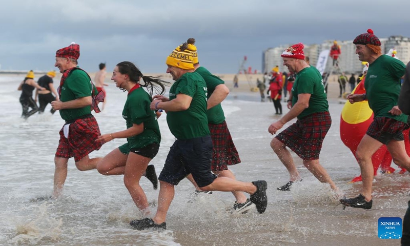 People take part in the traditional New Year's Dive in Ostend, Belgium, Jan. 6, 2024. Thousands of people braved the cold North Sea on Saturday to welcome the New Year. (Xinhua/Zhao Dingzhe)