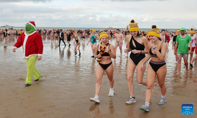 People take part in the traditional New Year's Dive in Ostend, Belgium, Jan. 6, 2024. Thousands of people braved the cold North Sea on Saturday to welcome the New Year. (Xinhua/Zhao Dingzhe)